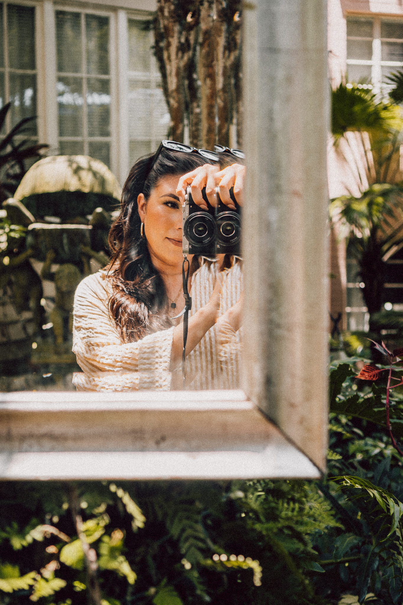 Latina woman taking a photo of herself in the mirror